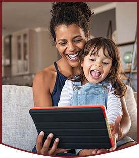 Happy mom and daughter learning together on a tablet computer
